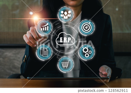 Businesswoman using ERP software on a tablet, showcasing digital transformation in enterprise management. 128562911