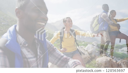 Composite of happy african american couple hiking on mountain, and stopping to admire the view Composite of happy african american couple hiking on mountain, and stopping to admire the view 128563697