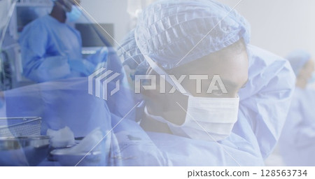 Composite of diverse male and female surgeon preparing for operating theatre 128563734