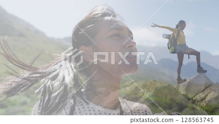 Composite of woman taking photo, and hiking on mountainside 128563745