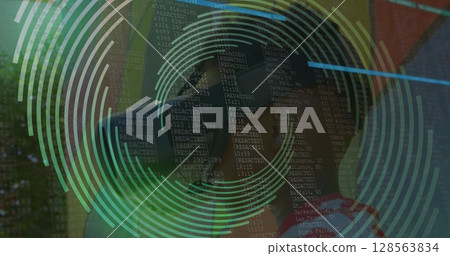 Image of spinning shapes over boy using vr headset 128563834