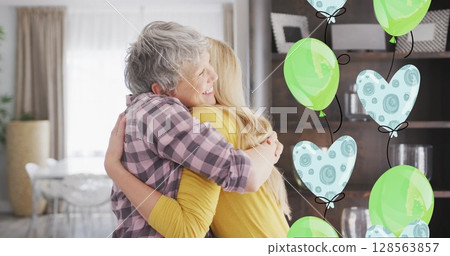 Image of balloons over happy caucasian mother and her adult daughter hugging at home Image of balloons over happy caucasian mother and her adult daughter hugging at home 128563857