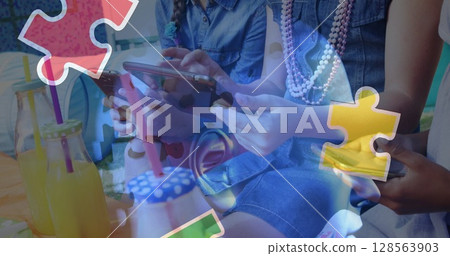 Image of colourful puzzle pieces and human head over children using tablets 128563903