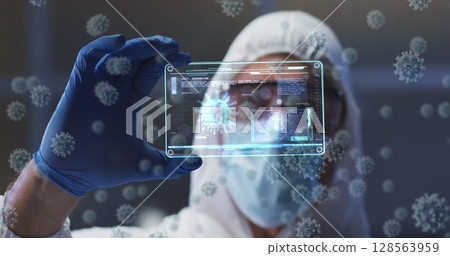 Image of virus cells and digital interface over male doctor wearing face mask 128563959