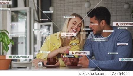 Image of social media icons floating over happy caucasian couple using smartphone having coffee Image of social media icons floating over happy caucasian couple using smartphone having coffee 128564001