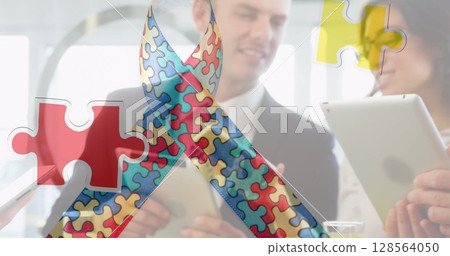 Image of colourful puzzle pieces ribbon over business people using digital devices 128564050