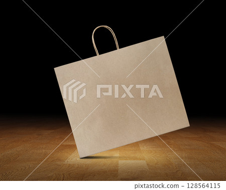 Big brown paper bag on wooden floor, black background. 128564115