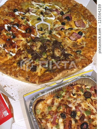 Classic combo of cheesy pizza with a crispy crust and savory spaghetti in rich tomato sauce. A comforting and satisfying meal perfect for sharing with friends or family. Classic combo of cheesy pizza with a crispy crust and savory spaghetti in rich tomato sauce. A comforting and satisfying meal perfect for sharing with friends or family. 128564289