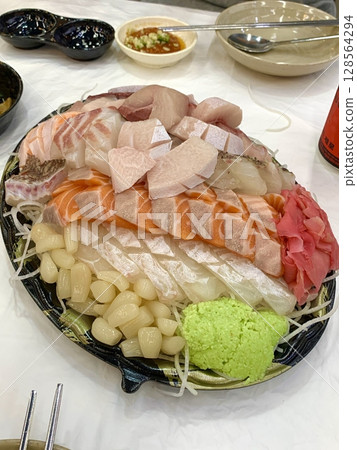 Fresh and delicate sashimi slices, beautifully presented with vibrant colors and perfect cuts. This traditional Japanese delicacy highlights the pure flavors of premium seafood. Fresh and delicate sashimi slices, beautifully presented with vibrant colors and perfect cuts. This traditional Japanese delicacy highlights the pure flavors of premium seafood. 128564294