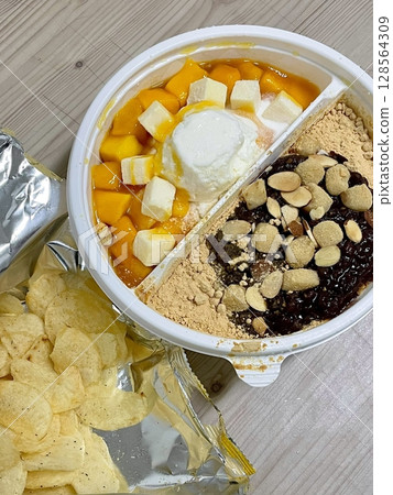 A refreshing bowl of bingsu, topped with fluffy shaved ice, vibrant fruits, and sweet toppings. Perfect for summer treats, this Korean dessert captures the essence of indulgence and delight. A refreshing bowl of bingsu, topped with fluffy shaved ice, vibrant fruits, and sweet toppings. Perfect for summer treats, this Korean dessert captures the essence of indulgence and delight. 128564309