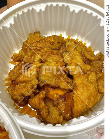 Guobaorou, a classic Chinese dish of crispy pork strips coated in a sweet and tangy sauce. Balanced flavors and crunch make it an irresistible comfort food choice. 128564312