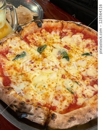 A delicious pizza with a golden crust, melted cheese, and savory toppings. Perfect for food-related designs, menus, or Italian-themed projects, capturing the essence of a classic comfort dish. A delicious pizza with a golden crust, melted cheese, and savory toppings. Perfect for food-related designs, menus, or Italian-themed projects, capturing the essence of a classic comfort dish. 128564316