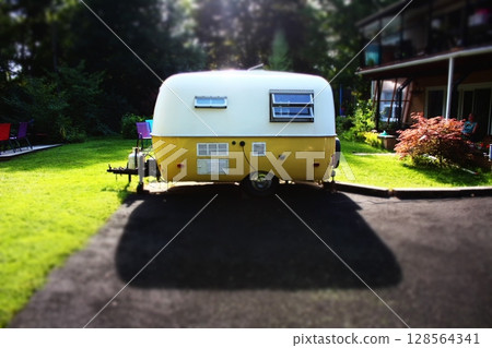 Vintage Boler Camper Trailer Parked in Driveway at Sunset Vintage Boler Camper Trailer Parked in Driveway at Sunset 128564341