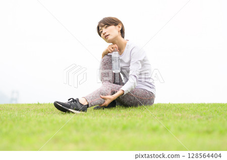 Woman getting a massage after exercise Woman getting a massage after exercise 128564404