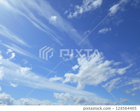White clouds flowing in the blue sky White clouds flowing in the blue sky 128564405