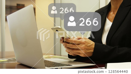 Image of icons and numbers over woman using smartphone and laptop 128564440