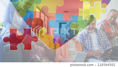 Image of colourful puzzle pieces heart over senior friends using tablets 128564502