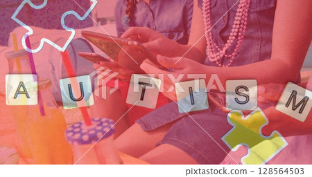 Image of colourful puzzle pieces and autism text over friends using smartphone and tablet 128564503