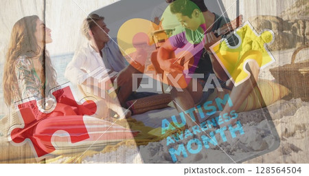 Image of colourful puzzle pieces heart and autism text over happy friends at summer beach party Image of colourful puzzle pieces heart and autism text over happy friends at summer beach party 128564504