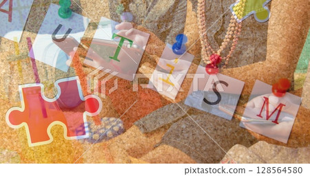 Image of colourful puzzle pieces and autism text over friends using smartphone and laptop Image of colourful puzzle pieces and autism text over friends using smartphone and laptop 128564580