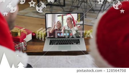 Image of christmas decorations over caucasian father and son in santa hats on laptop image call 128564708