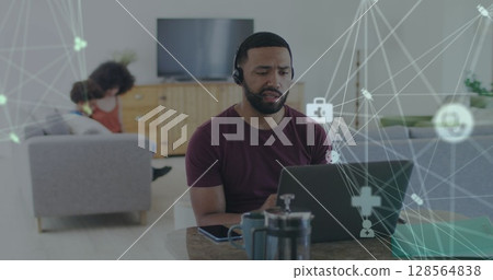 Image of network of connections over man using laptop 128564838