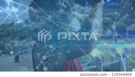 Image of network of connections over fit african american senior man drinking water outdoors 128564869