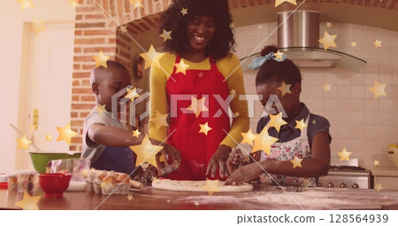 Image of stars falling over happy african american mother with children baking at christmas Image of stars falling over happy african american mother with children baking at christmas 128564939