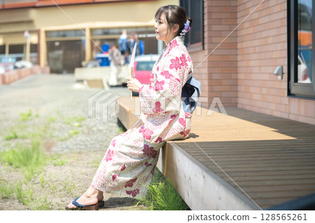 A woman in a yukata cooling off 128565261