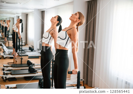 Women in fitness center are doing exercises 128565441