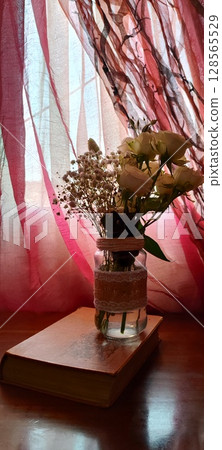 Still life of roses in vintage mason jar. Still life with book, coffee, and flowers. 128565529