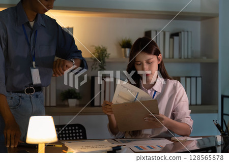 Time Management in Office. Professional checking watch while reviewing documents. 128565878