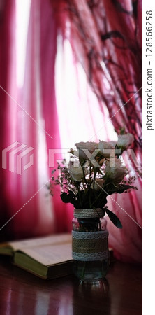 Still life of roses in vintage mason jar. Still life with book, coffee, and flowers. 128566258