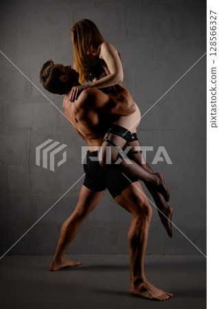 Couple in intimate pose showcasing beauty and allure in a stylish setting 128566327