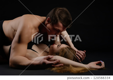 Couple embraces intimately in a sensual moment capturing beauty and desire Couple embraces intimately in a sensual moment capturing beauty and desire 128566334