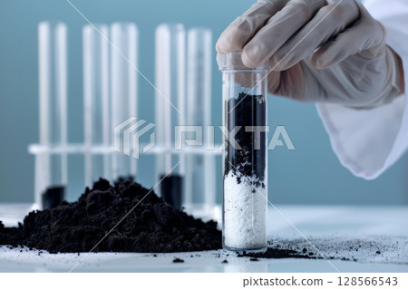 A scientist in a lab coat is carefully placing an air layer in a test tube as part of an experimental study on material properties 128566543