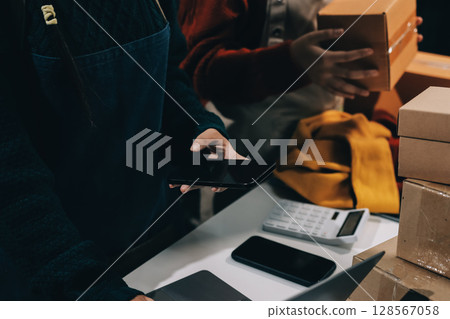 Portrait of Starting small businesses SME owners, two Asian woman check online orders Selling products working with boxs freelance work at home office, sme business online small medium enterprise 128567058