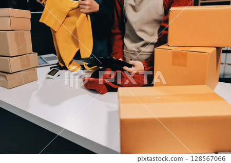 Portrait of Starting small businesses SME owners, two Asian woman check online orders Selling products working with boxs freelance work at home office, sme business online small medium enterprise Portrait of Starting small businesses SME owners, two Asian woman check online orders Selling products working with boxs freelance work at home office, sme business online small medium enterprise 128567066