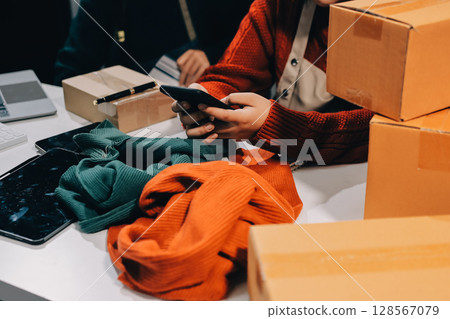 Portrait of Starting small businesses SME owners, two Asian woman check online orders Selling products working with boxs freelance work at home office, sme business online small medium enterprise 128567079