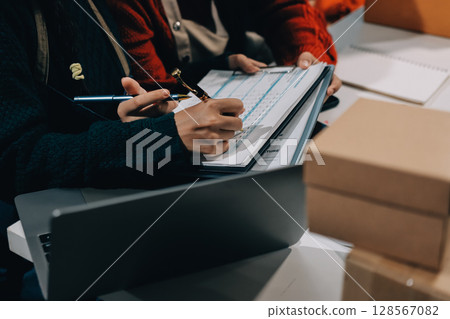 Portrait of Starting small businesses SME owners, two Asian woman check online orders Selling products working with boxs freelance work at home office, sme business online small medium enterprise 128567082