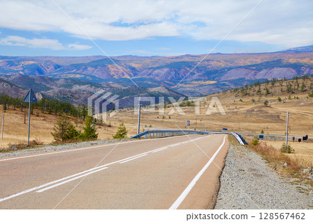 Paved empty road to Lake Baikal. Beautiful landscape surrounded by mountains 128567462