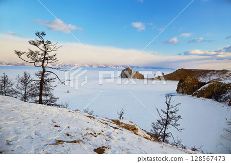 View of Cape Burhan or Shamanka rock on Olkhon island in winter. Frozen Lake Baikal 128567473