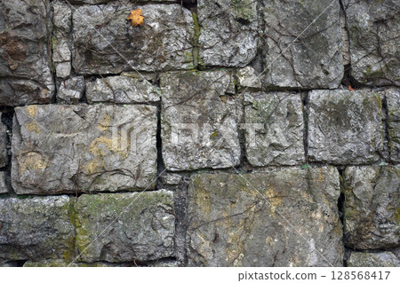 Texture of old big stone wall. Backdrop of medieval historic building 128568417