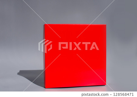Minimalistic red box with shadow on gray background 128568471