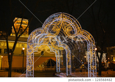 Illuminated gazebo in winter park with festive lights at night 128568482