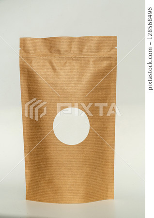 Brown kraft paper pouch with round window for eco-friendly packaging Brown kraft paper pouch with round window for eco-friendly packaging 128568496