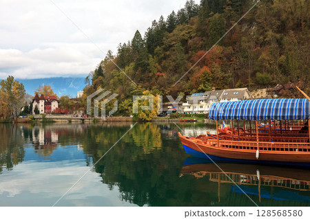 Autumn landscape with lake Bled and wooden boat in Slovenia Autumn landscape with lake Bled and wooden boat in Slovenia 128568580