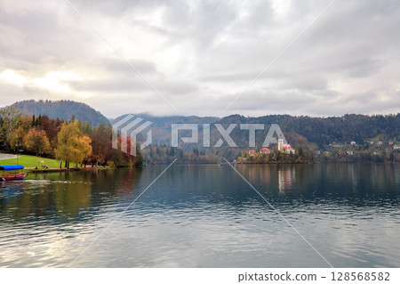 Autumn landscape with lake Bled and church in Slovenia at sunset 128568582