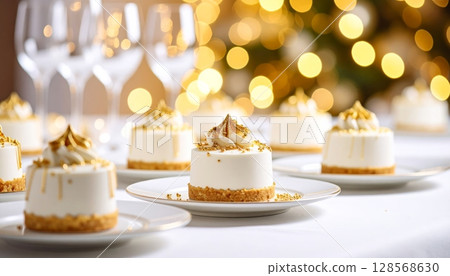 A gourmet Christmas cake dessert with festive candles adorns a beautifully set table, alongside delicious pastries and cups of coffee A gourmet Christmas cake dessert with festive candles adorns a beautifully set table, alongside delicious pastries and cups of coffee 128568630