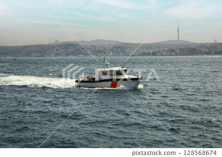 A patrol boat operates on the sea close to Istanbul's coastline 128568674